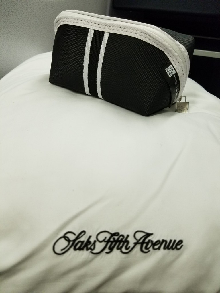a black and white bag on a white pillow