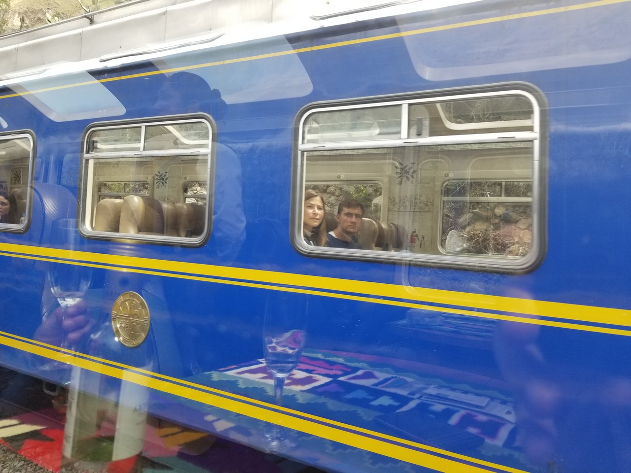 a blue train with people in it