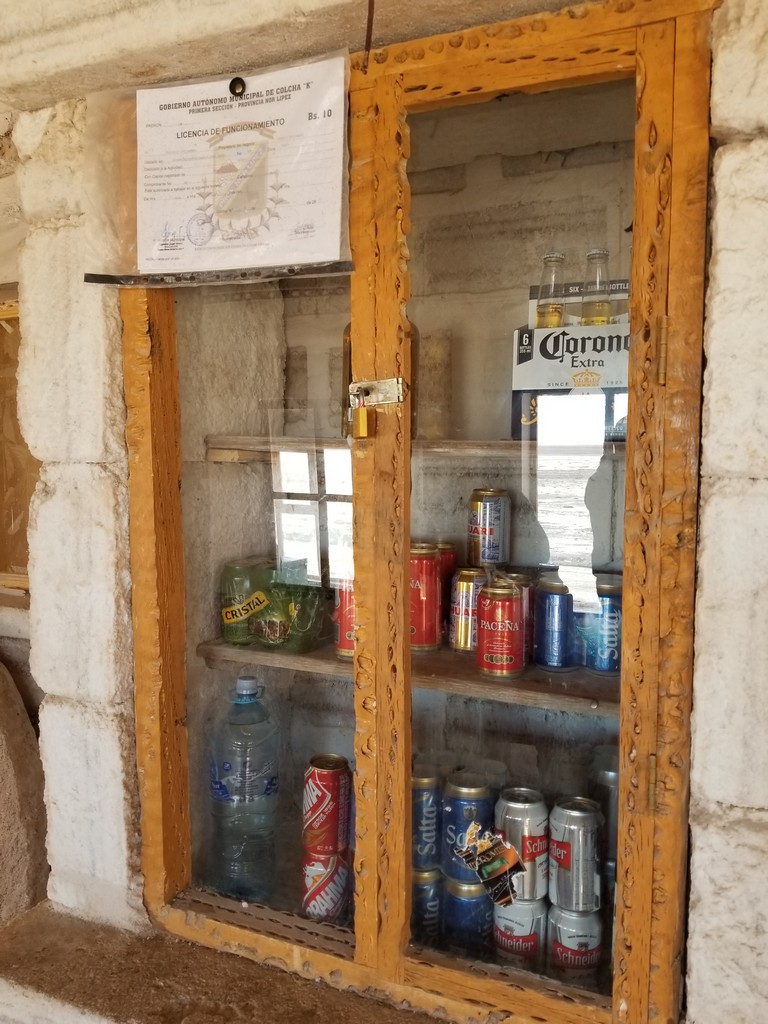 a glass cabinet with cans and cans on it
