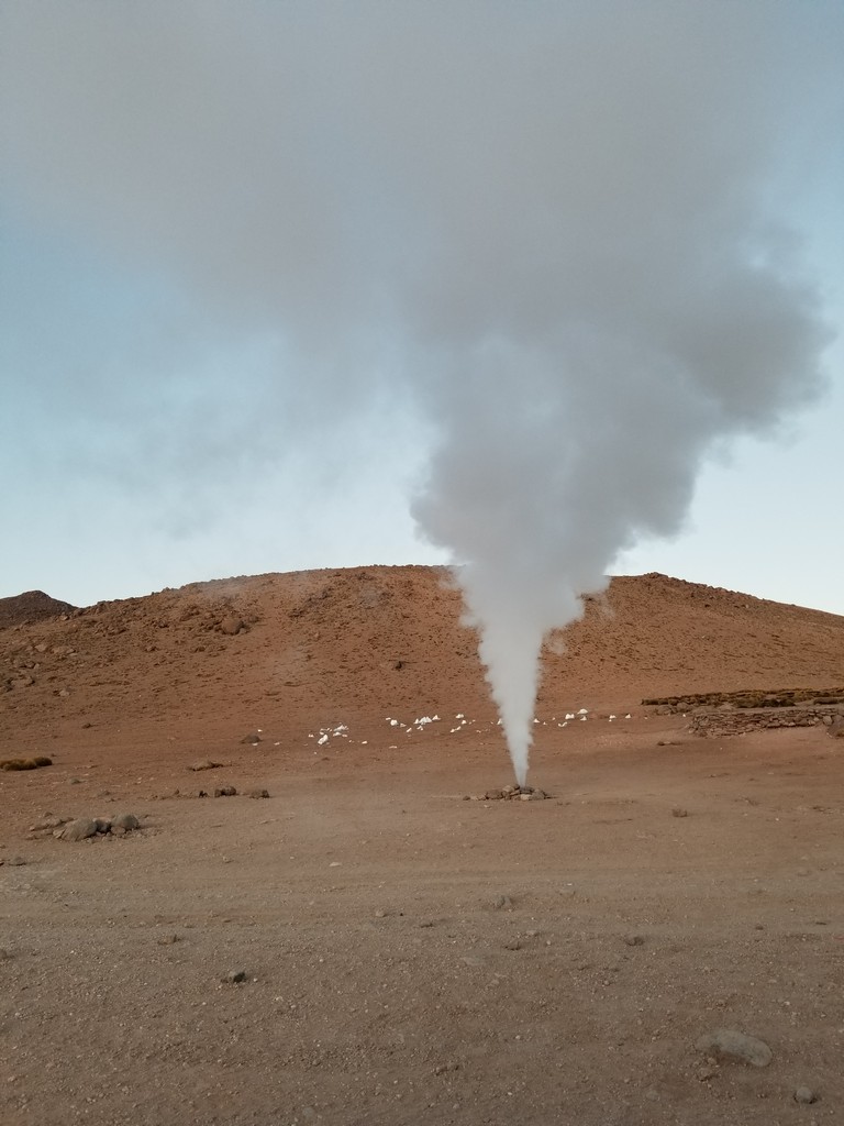 a steam coming out of a mound of dirt
