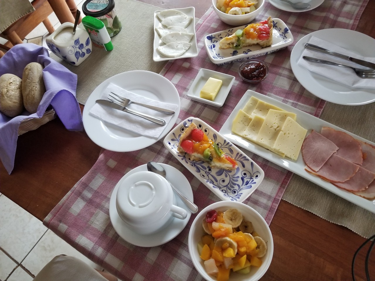 a table with plates of food and utensils