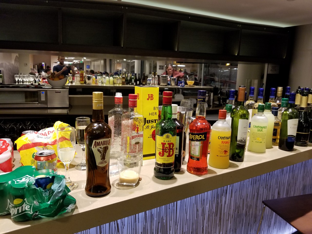 a group of bottles of alcohol on a bar