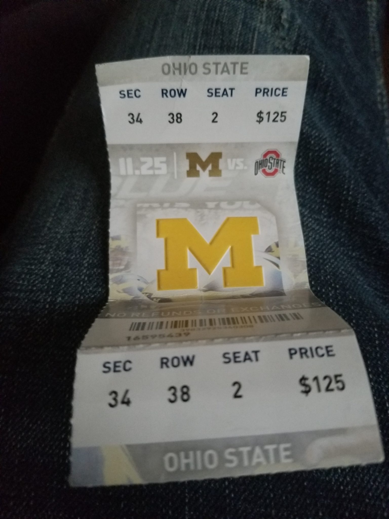 a paper ticket with a yellow letter on it