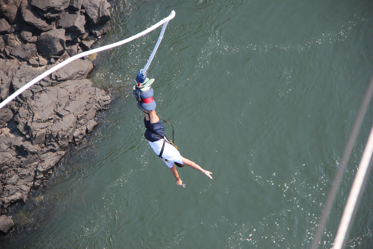 a person bungee jumping over water