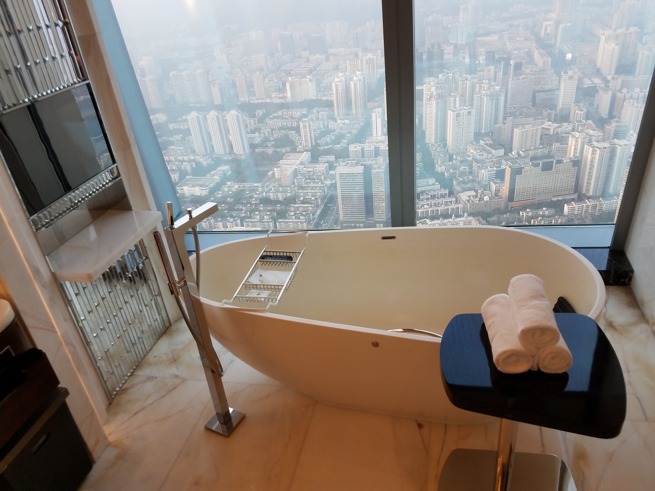a bathtub with a view of a city