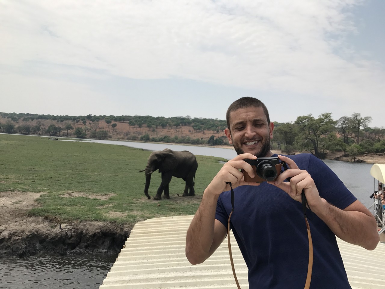 a man taking a picture of an elephant