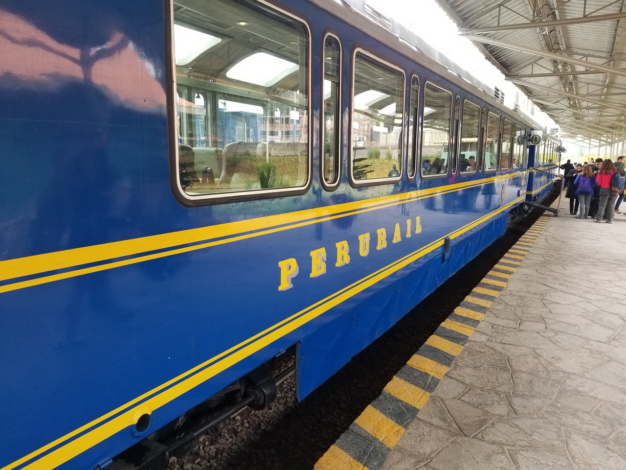 a blue train at a train station