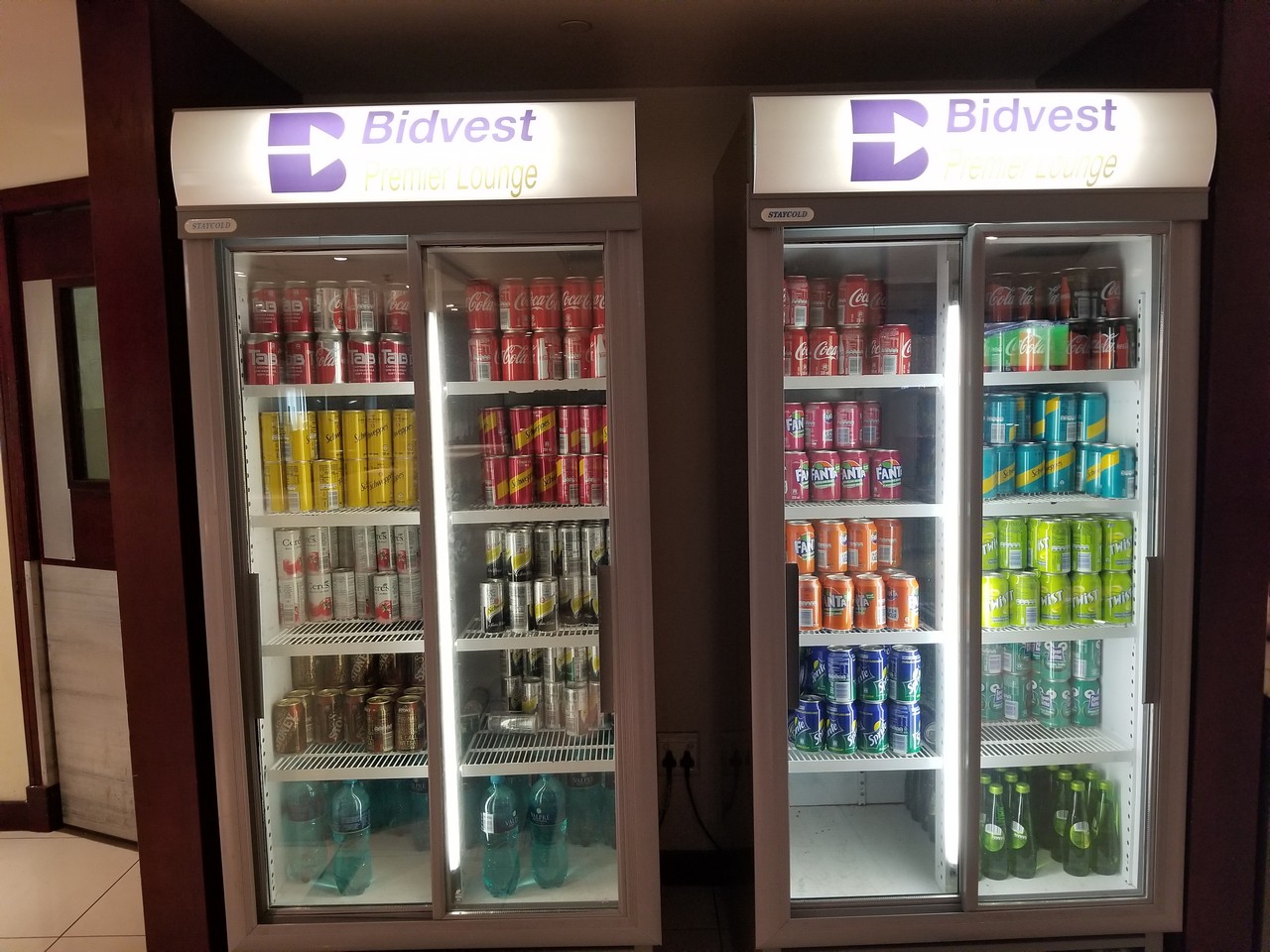 a coolers with cans of soda and cans of different colors