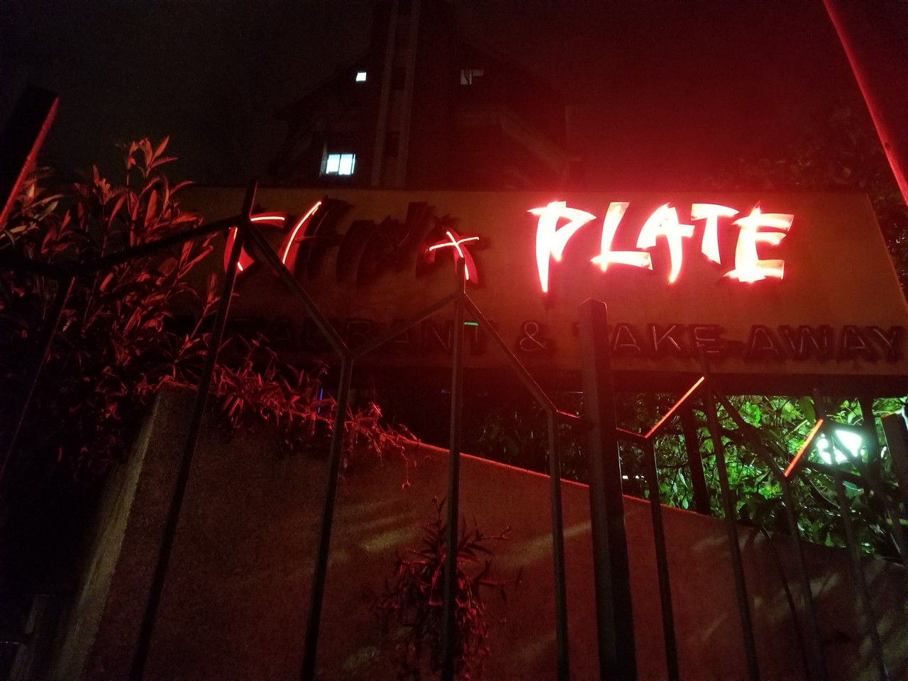 a sign with red lights at night
