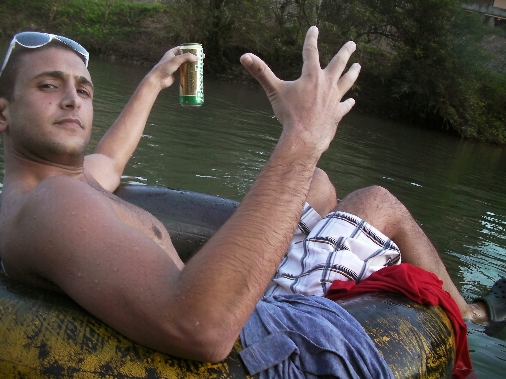 a man in a raft holding a can