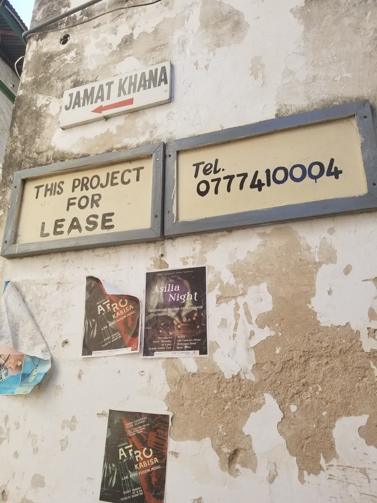 signs on a wall with posters