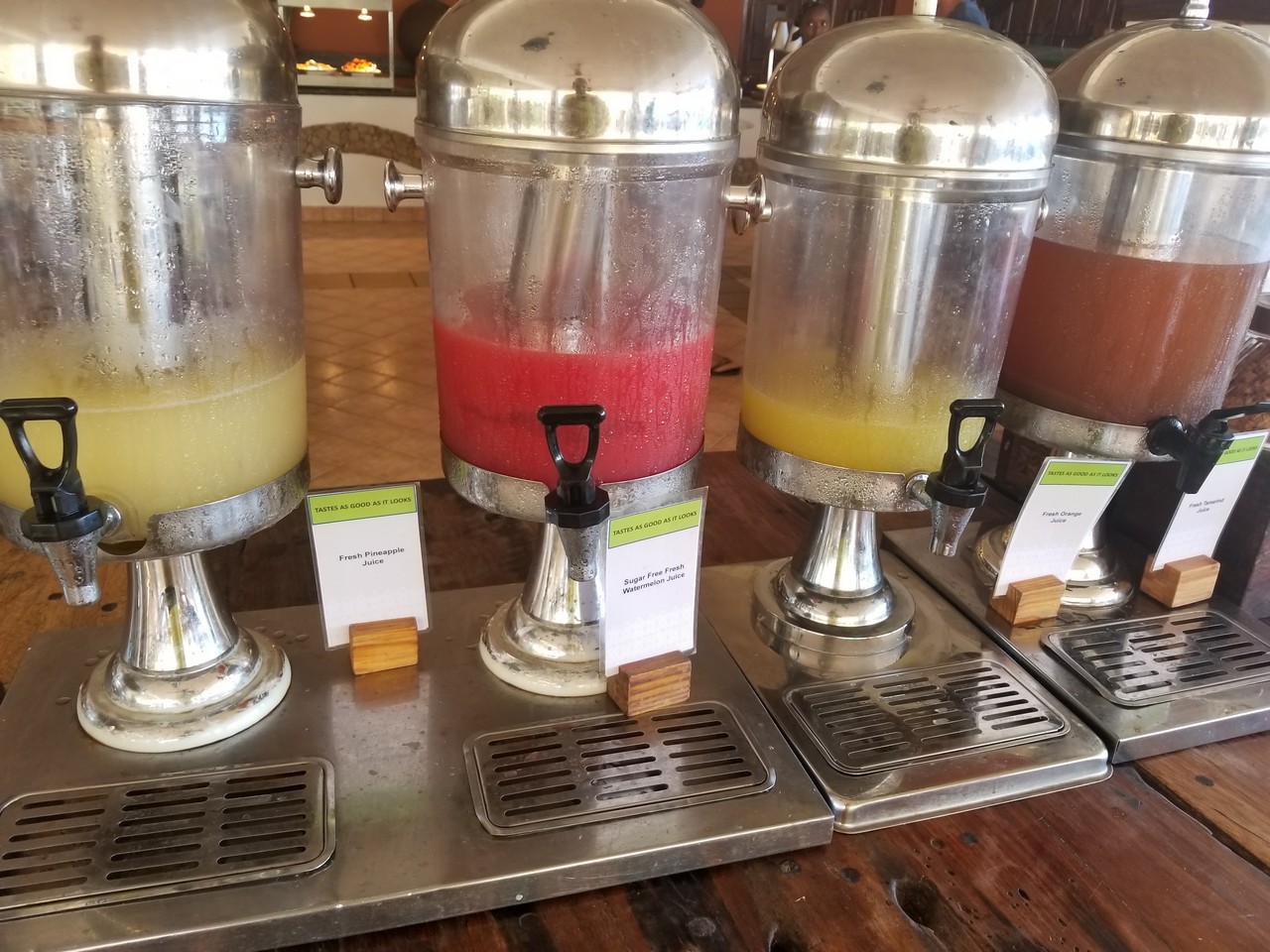 a row of beverage dispensers on a table