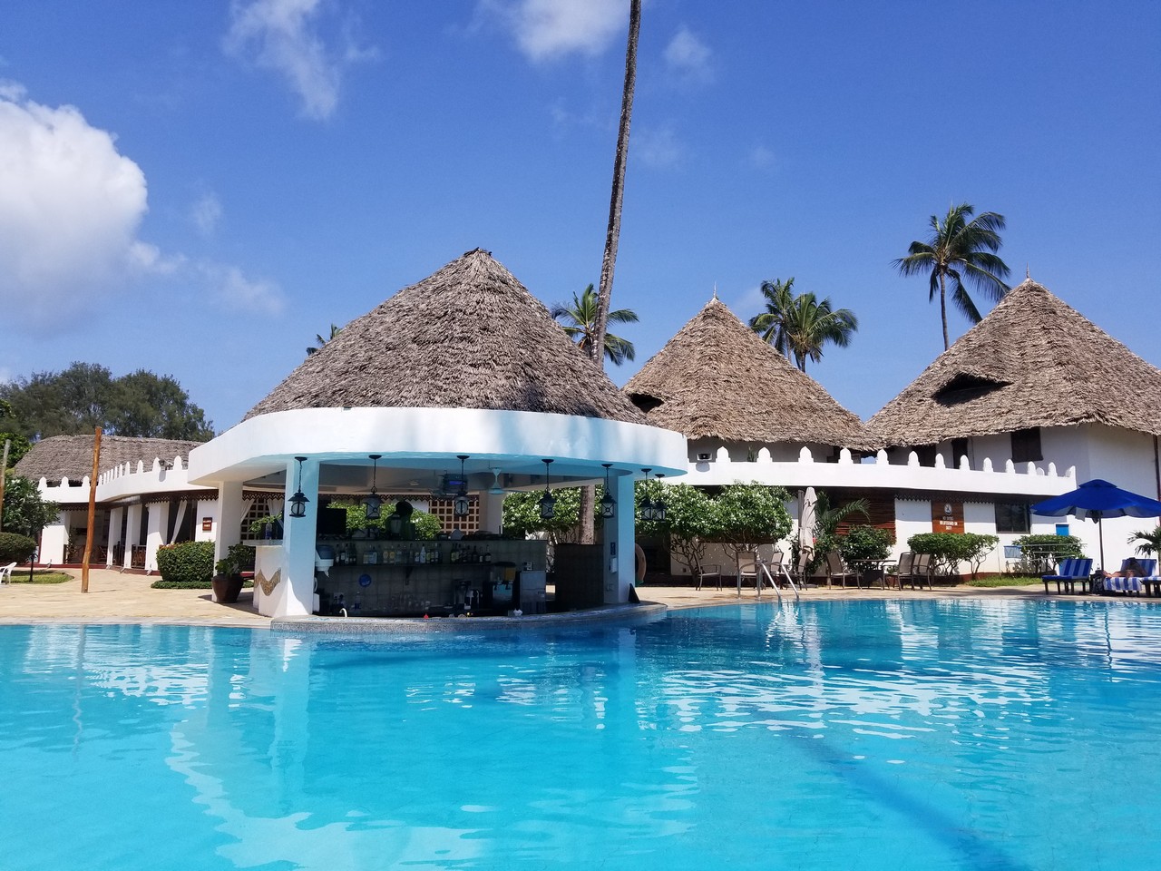 a pool with a bar and a bar in the background