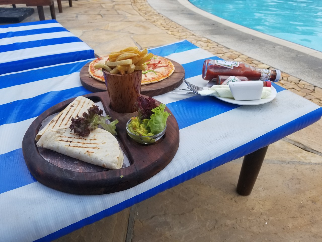 food on a table by a pool