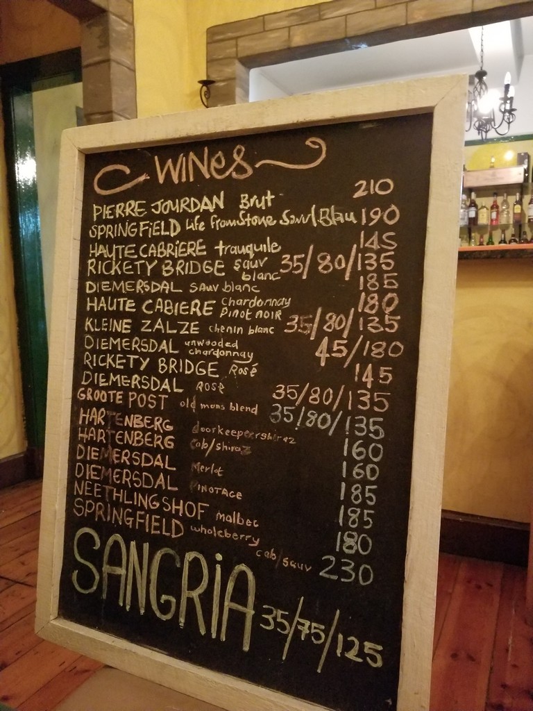 a chalkboard with a list of wine