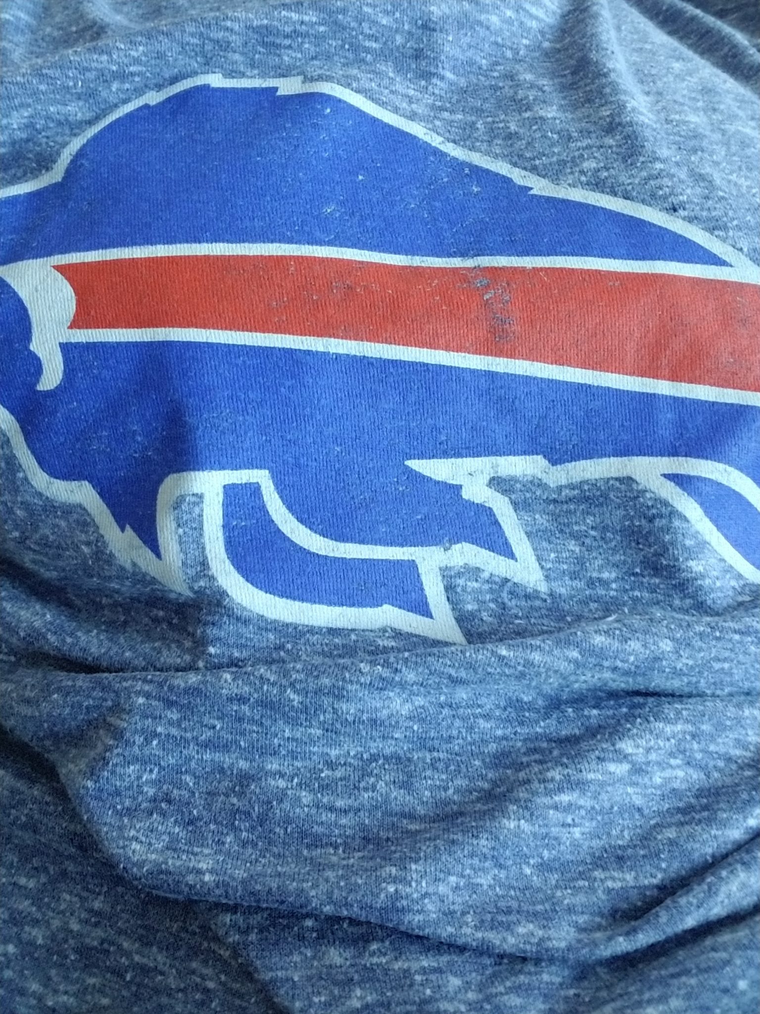 a blue and red buffalo logo on a grey shirt