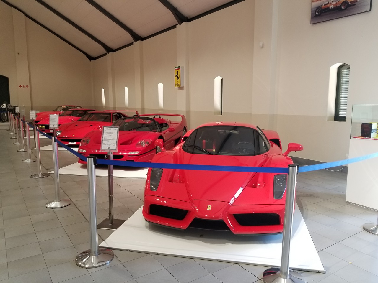 a red sports cars on display in a building