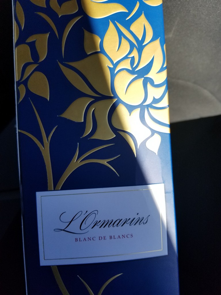 a blue and gold box with a white label
