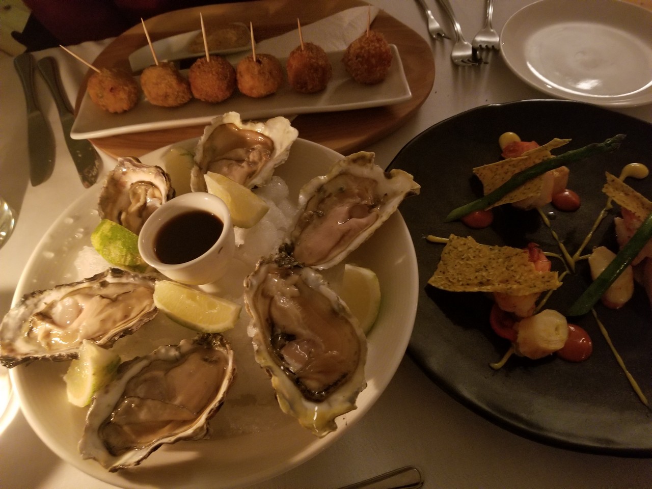 a plate of oysters and a plate of food