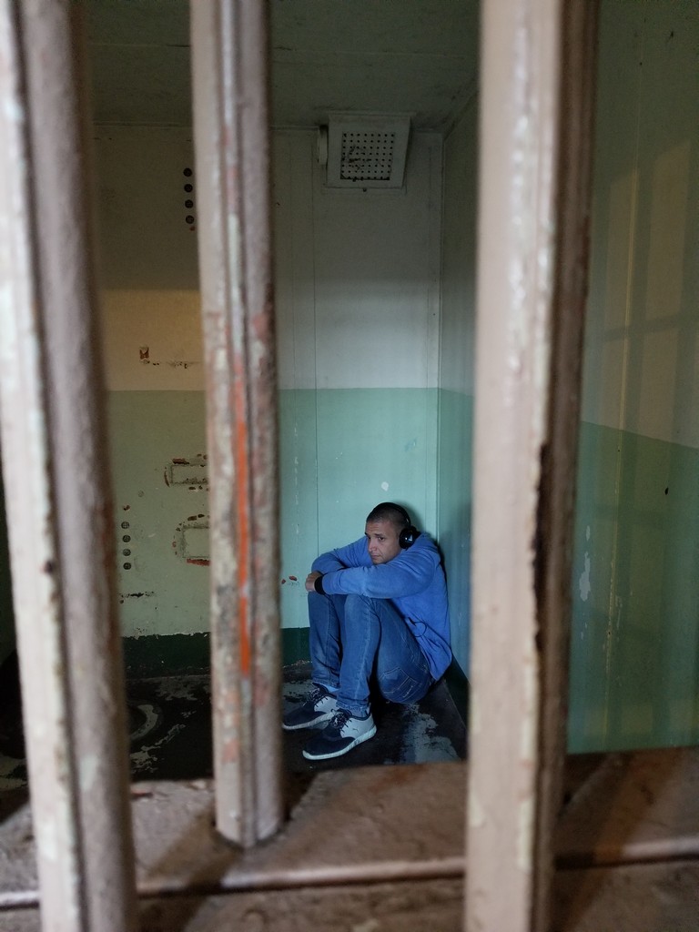 a man sitting in a cell