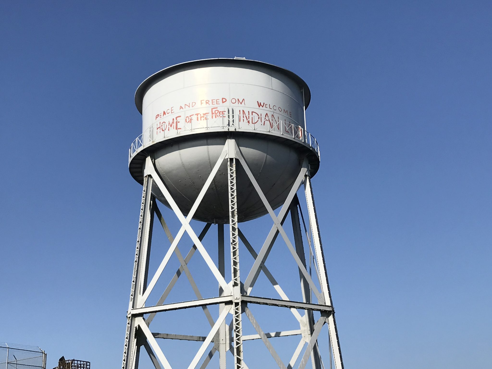 a water tower with graffiti on it