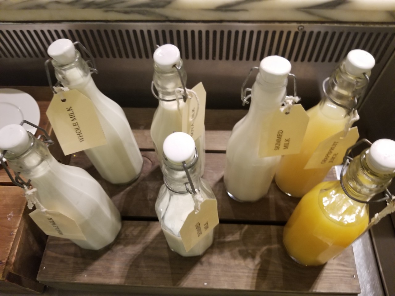 a group of bottles of milk and juice