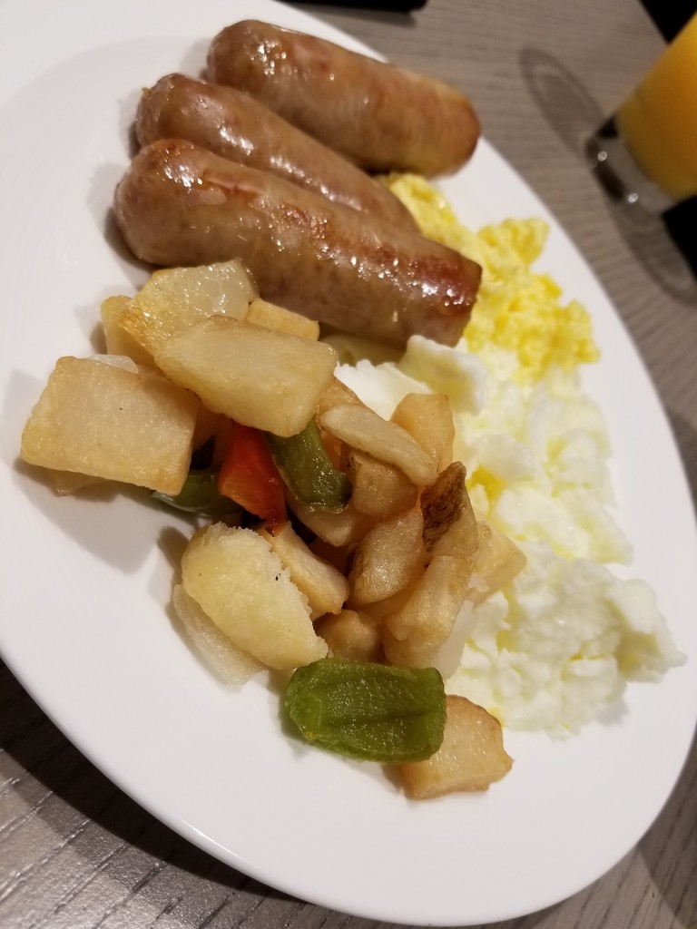 a plate of food with sausages and potatoes