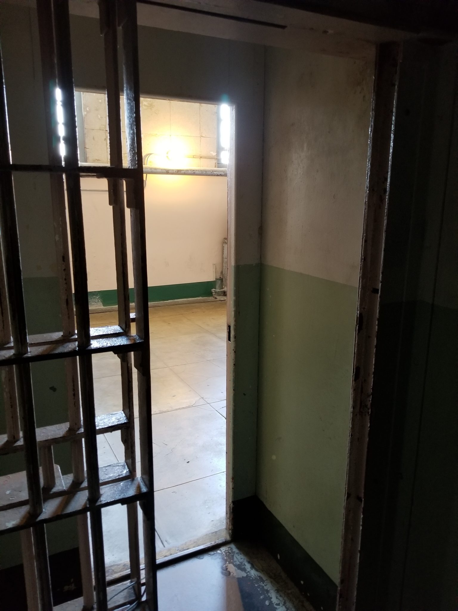 a prison cell door with bars