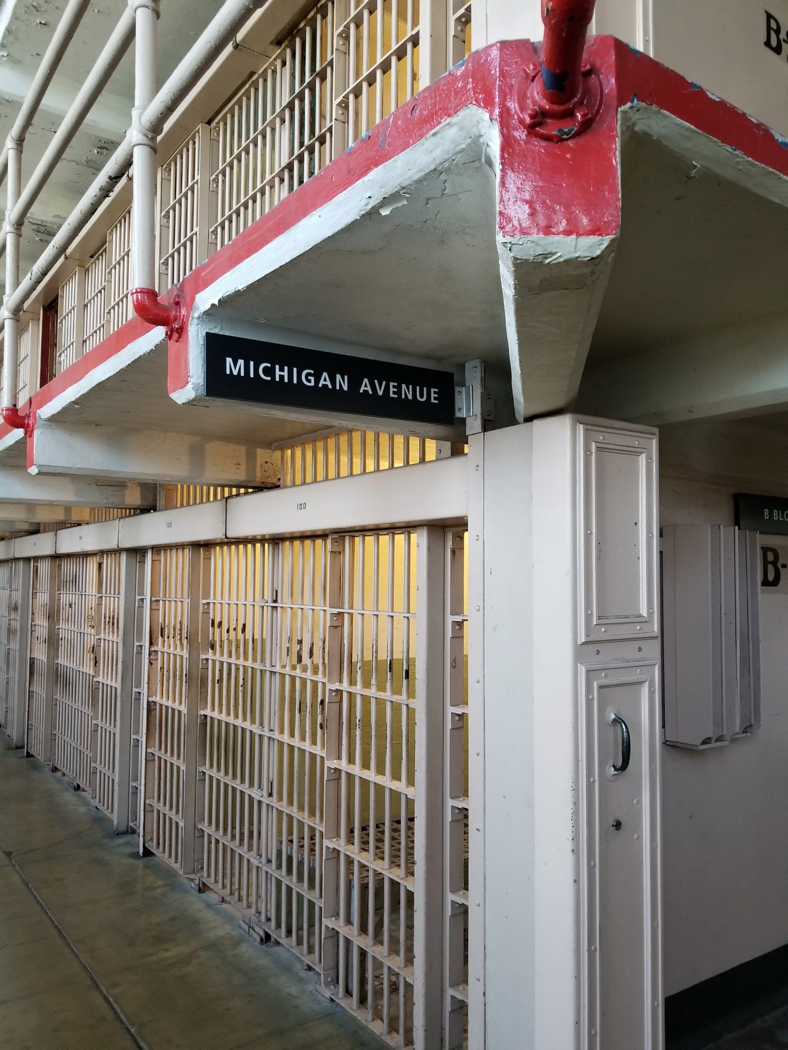a prison cell block with a sign