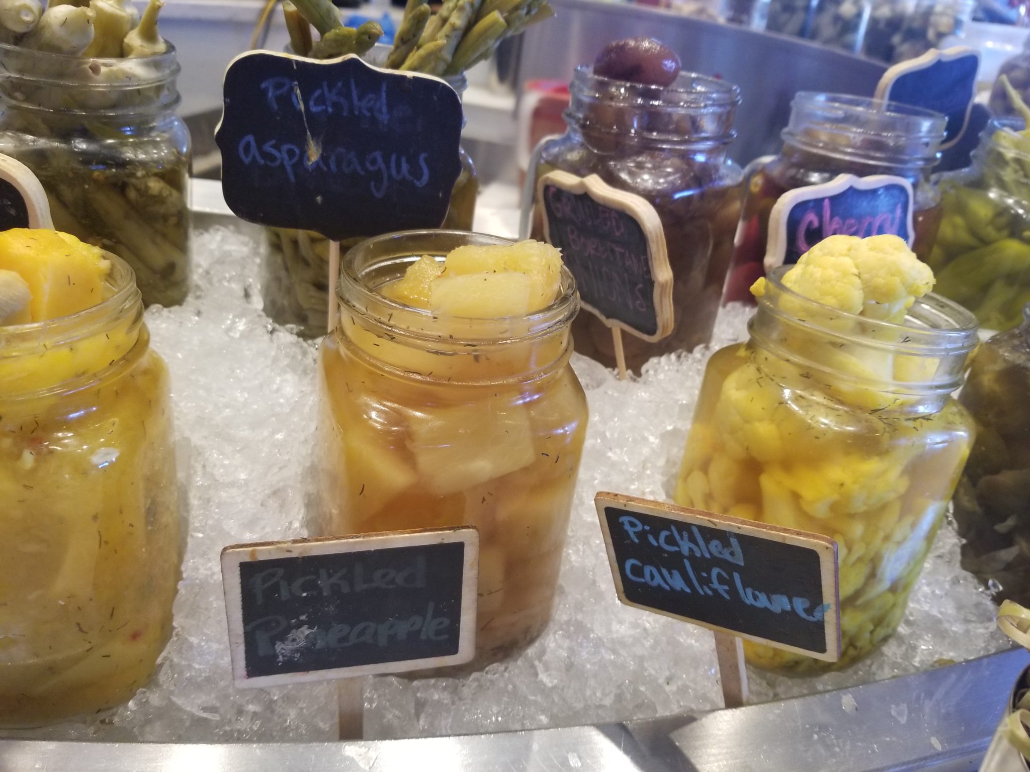 jars of pickled vegetables on ice