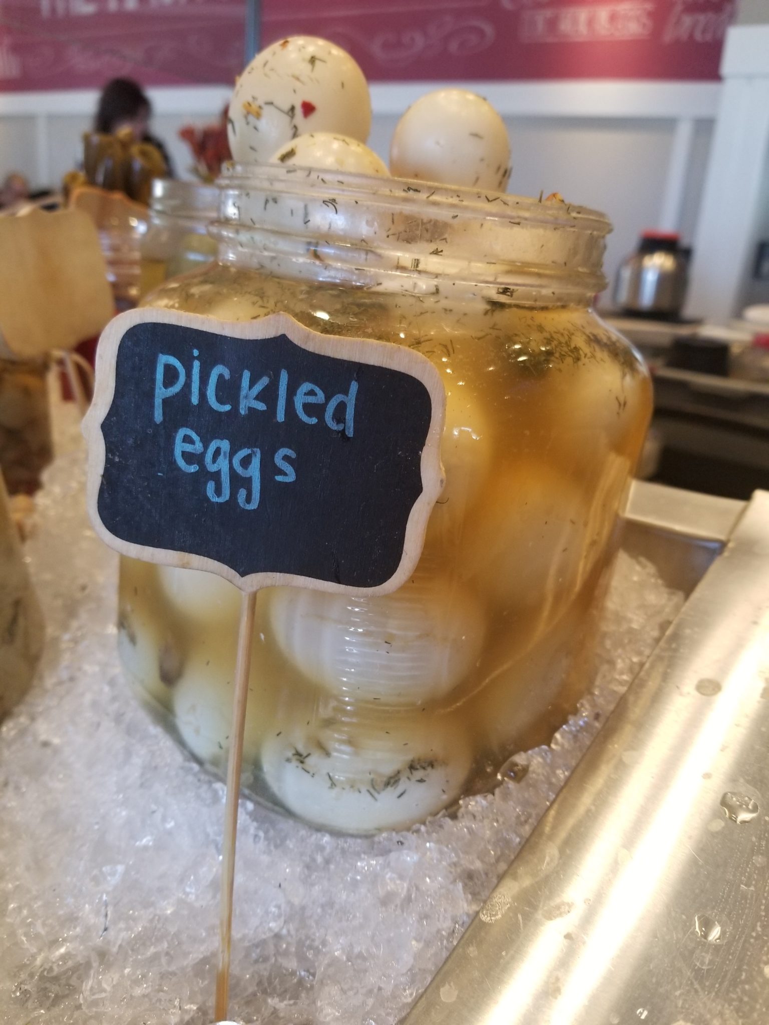 a jar of pickled eggs on ice