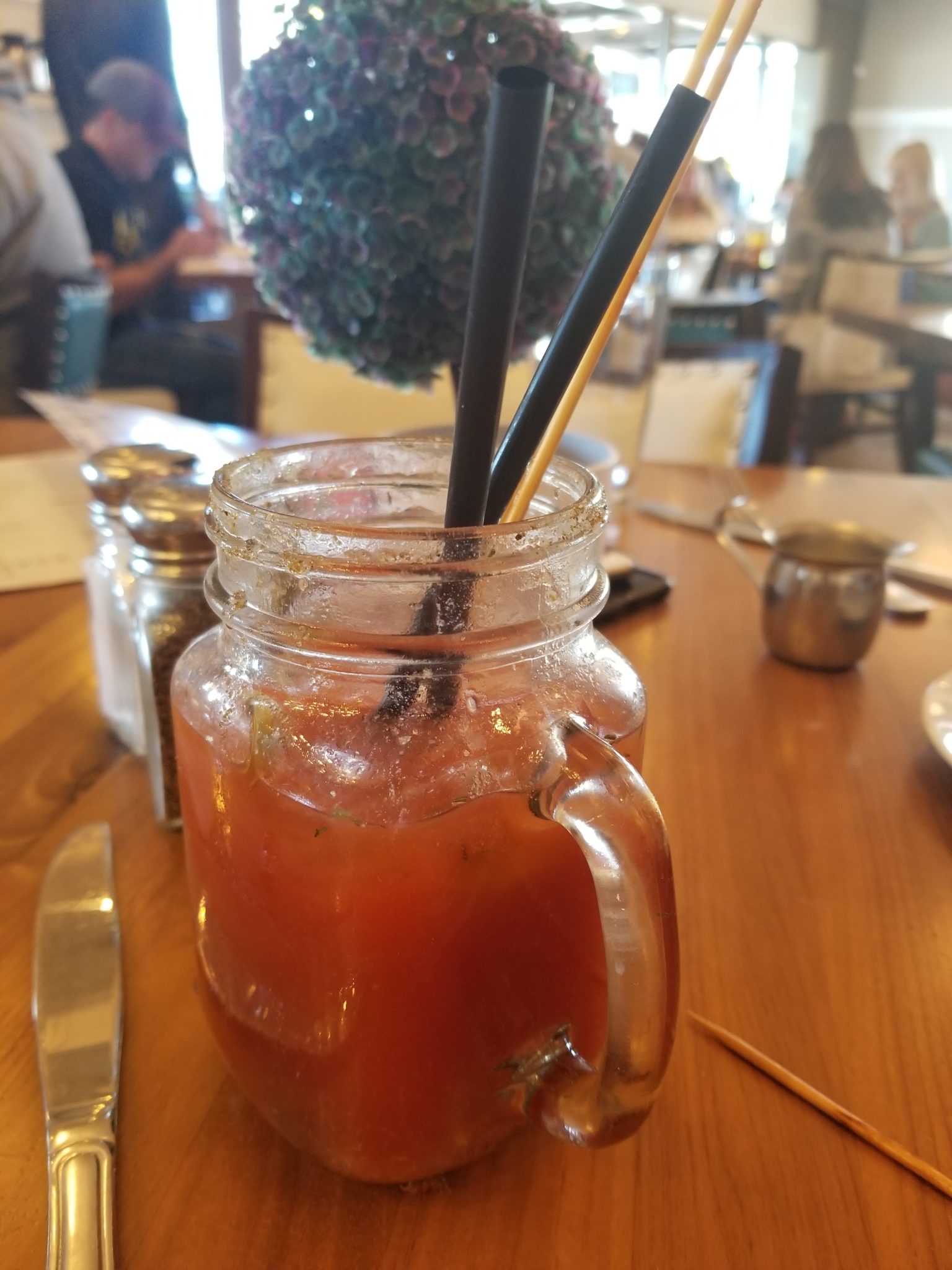 a glass jar with a drink in it