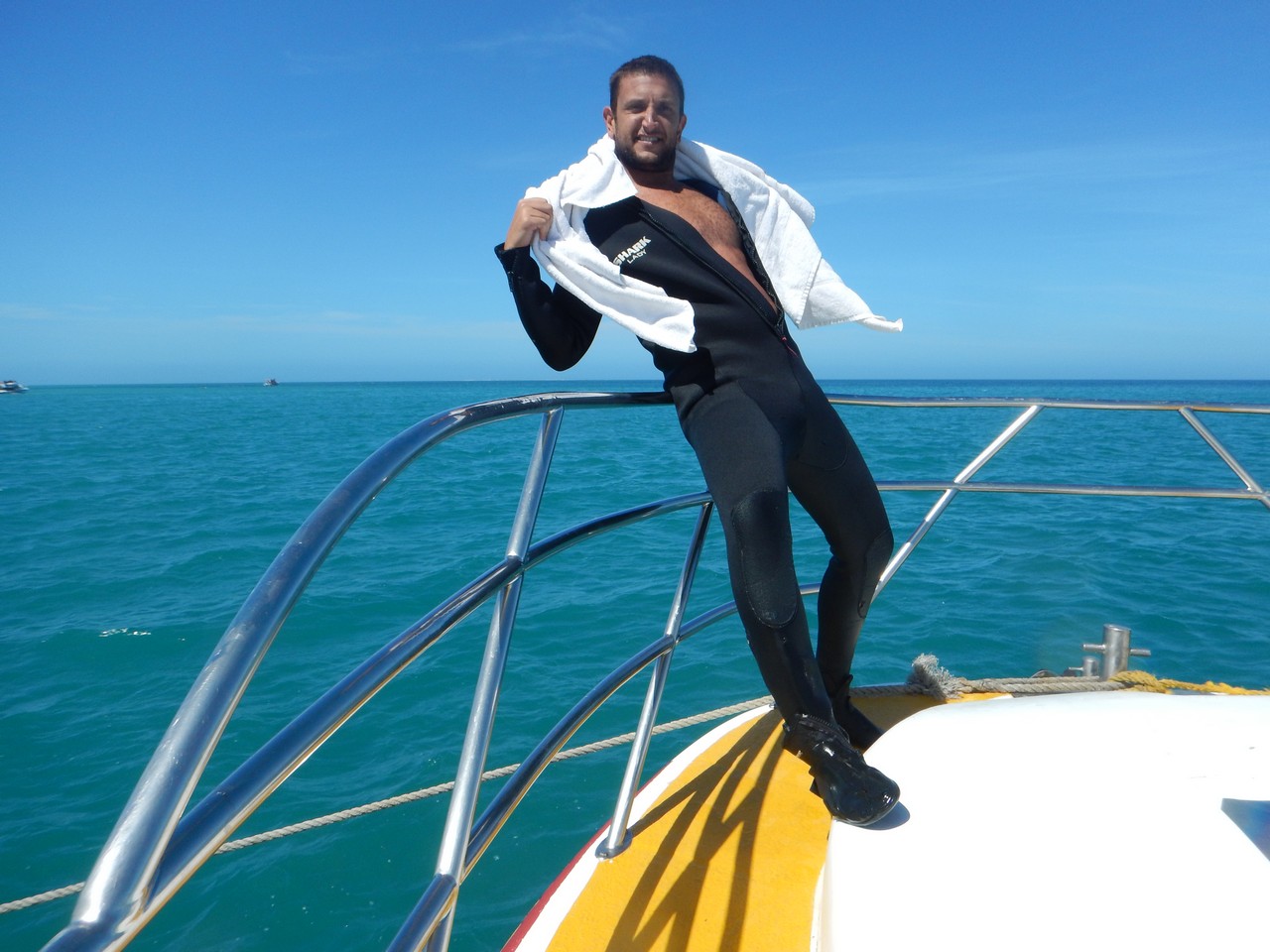 a man in a wet suit on a boat