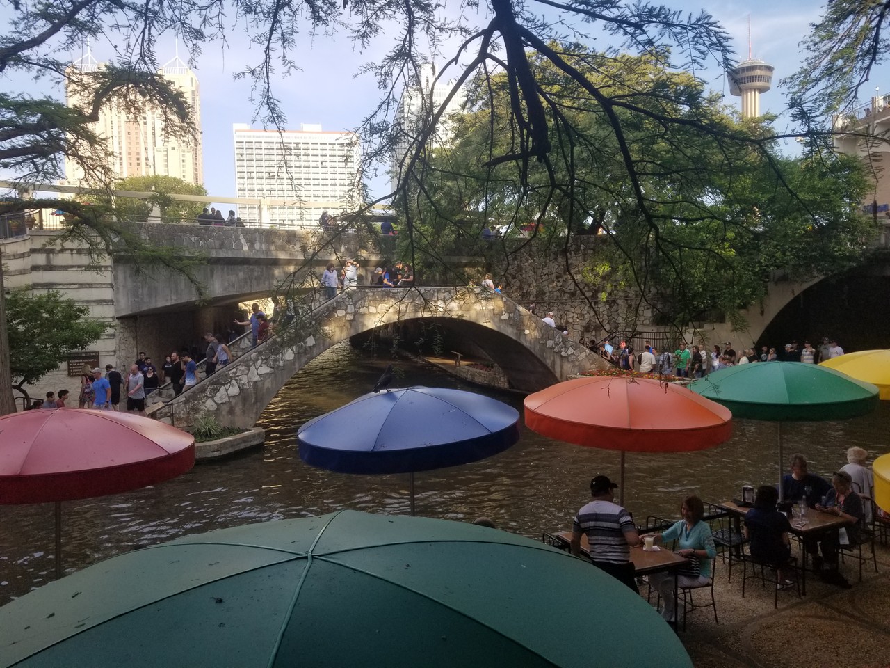 a group of people under umbrellas on a river