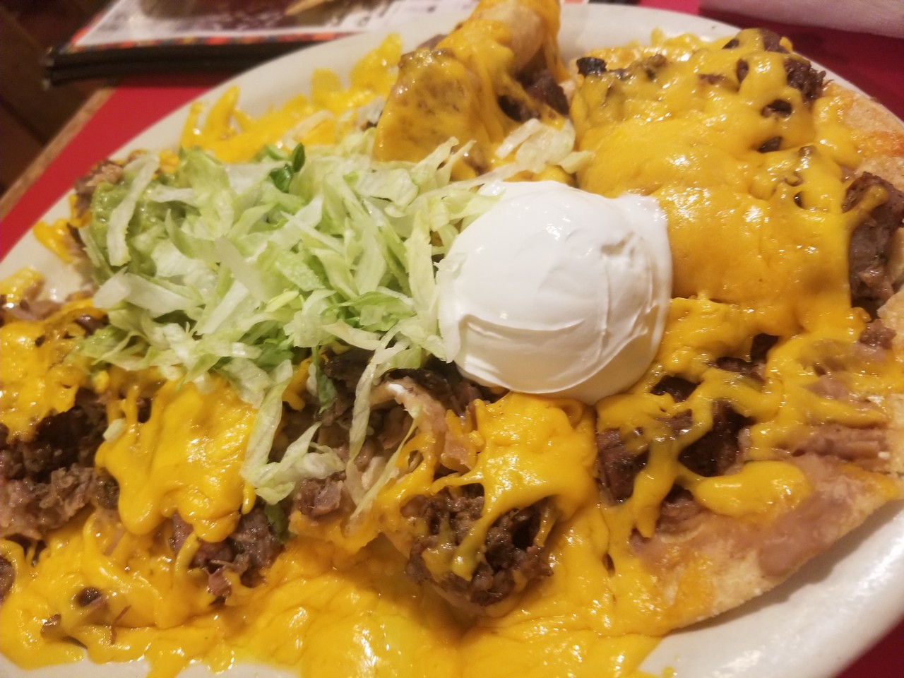 a plate of food with cheese and lettuce