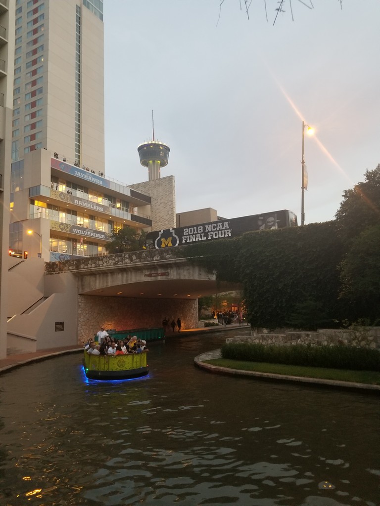 a boat on a river under a bridge