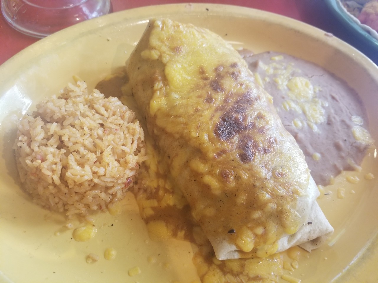 a plate of food with rice and burrito
