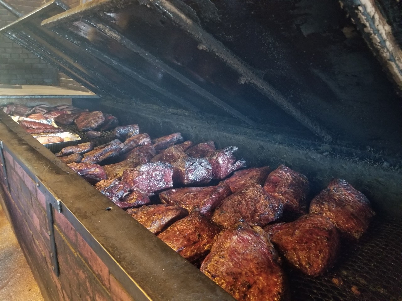 a large grill with meat on it