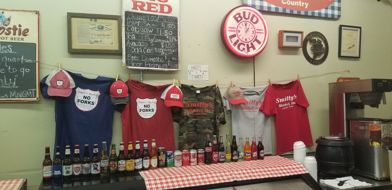 a table with a table with bottles of beer and a sign