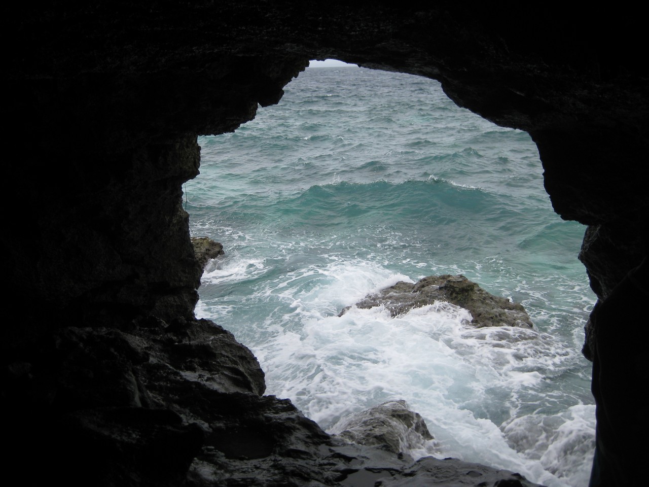 a cave with waves crashing on rocks