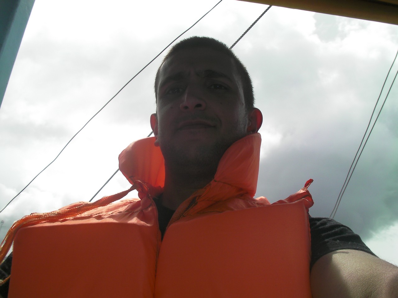 a man wearing an orange life jacket