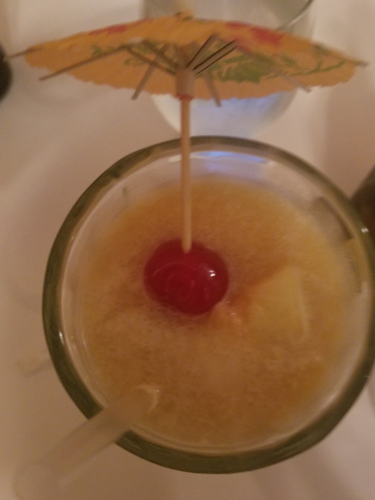 a cocktail with a cherry in the center of it