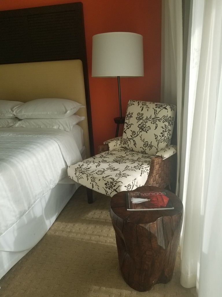 a chair next to a bed