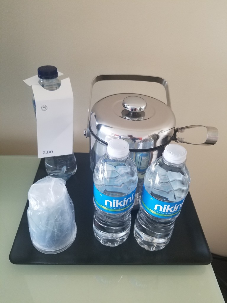 a group of water bottles and a container on a table