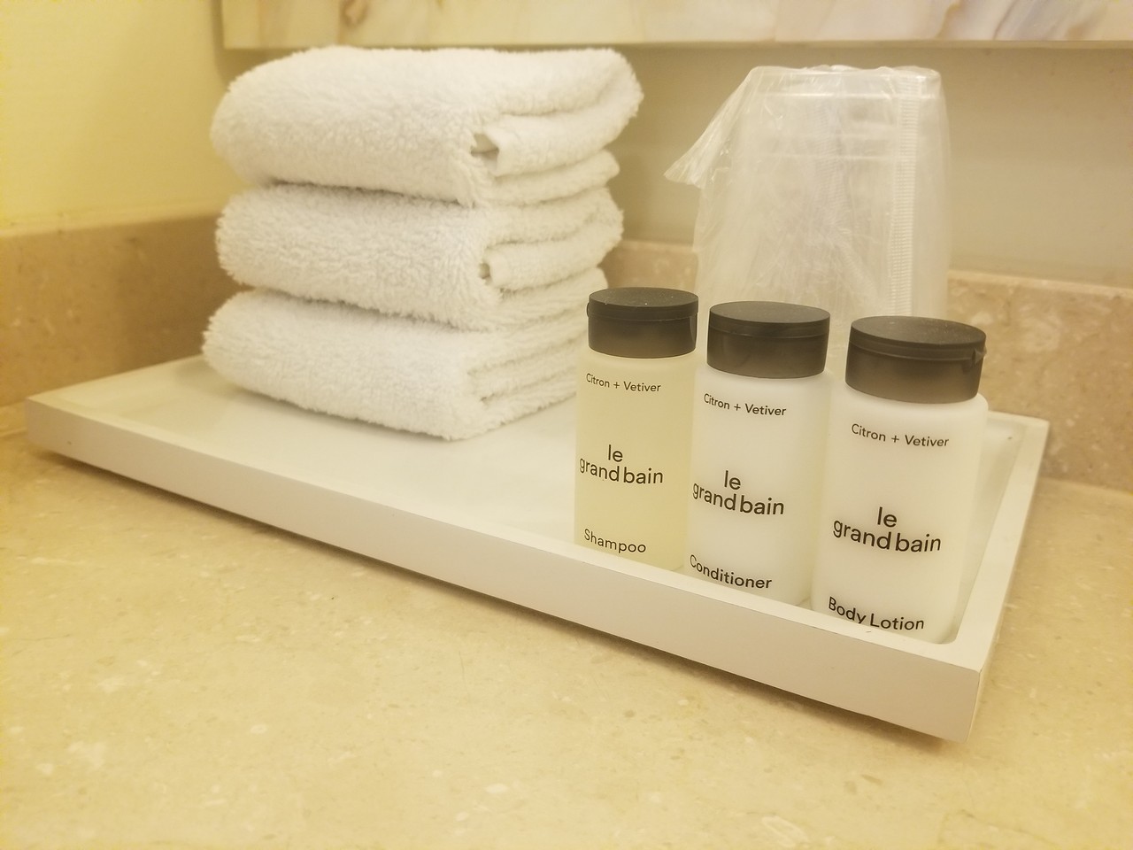 a white towel and bottles on a tray