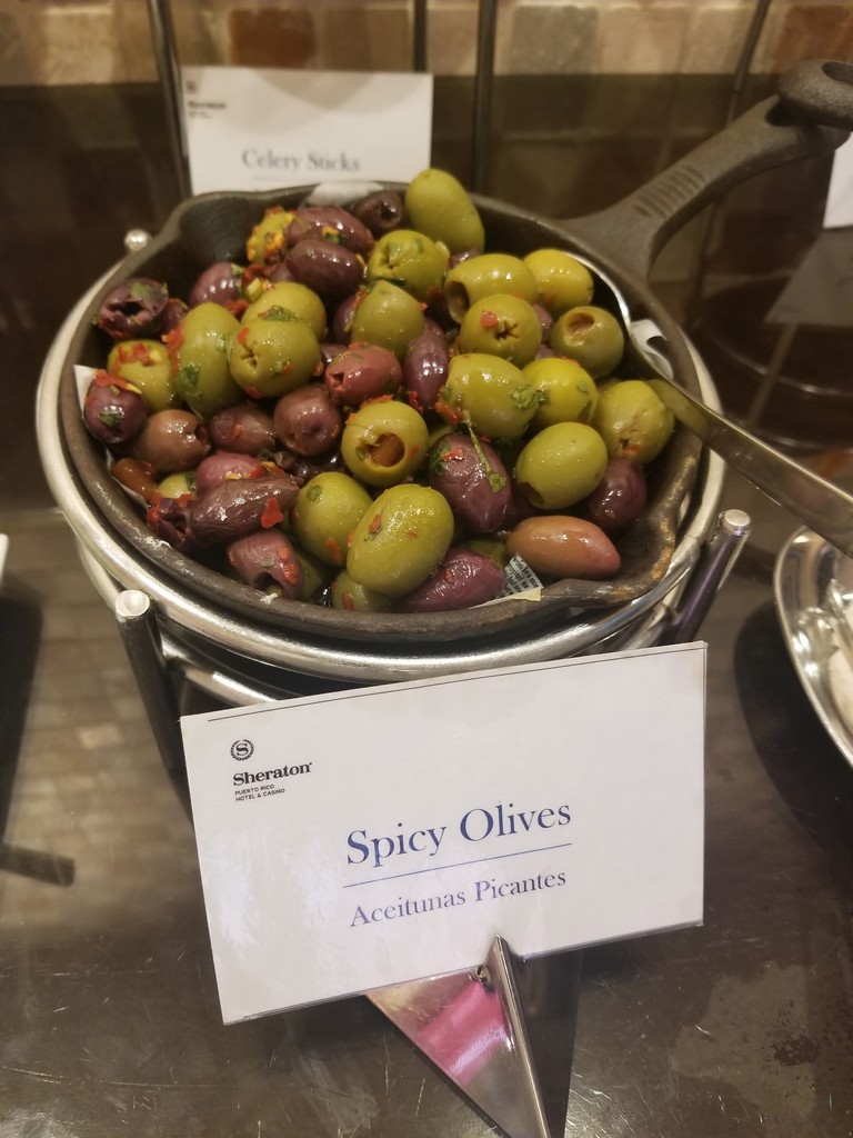 a bowl of olives on a table