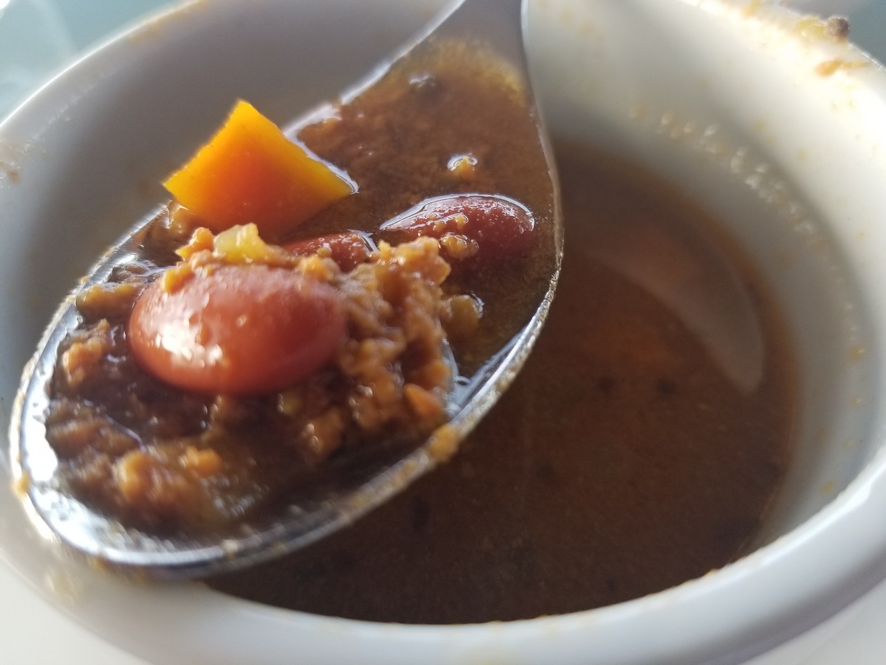 a spoonful of soup in a bowl