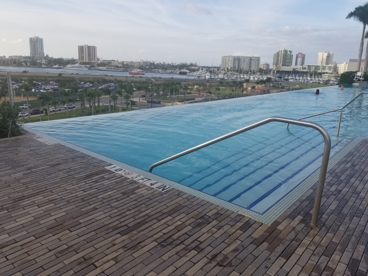 a pool with a railing on top of a building