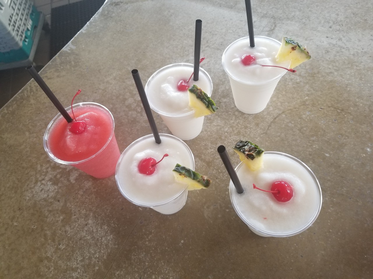 a group of drinks with straws