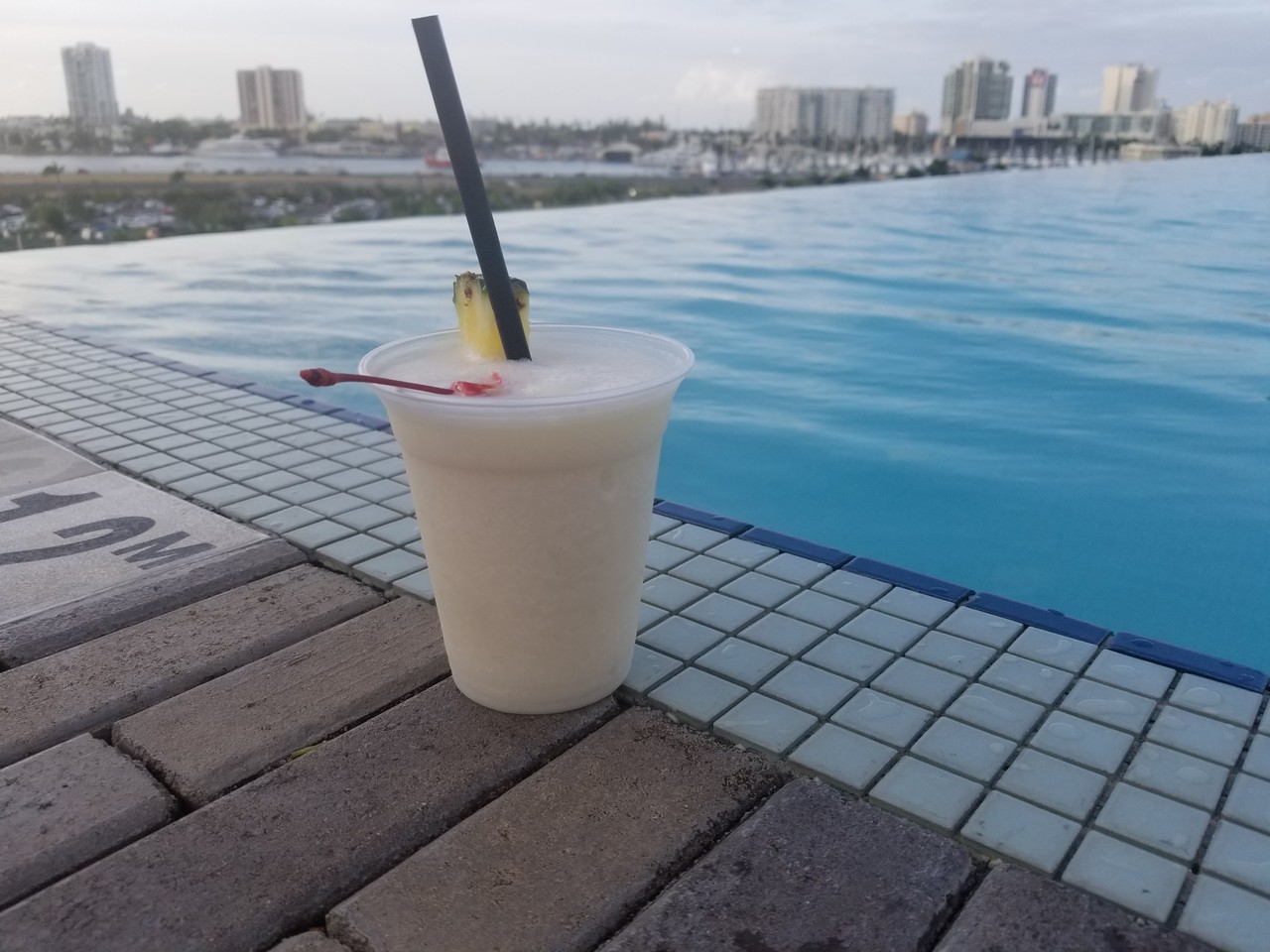 a drink on the edge of a pool